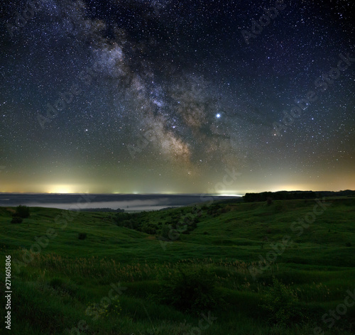 Stars in the sky at night. Bright milky way over the horizon with fog. Photographed with a long exposure.