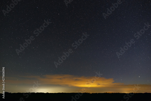 Stars of the Milky Way in the sky at night. Outer space and clouds. Photographed with a long exposure.