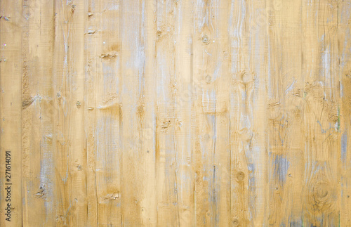 Natural wooden background. Surface of wooden texture for design and decoration. Shabby vertical boards with peeling paint. Light brown and gray color. Copy space.