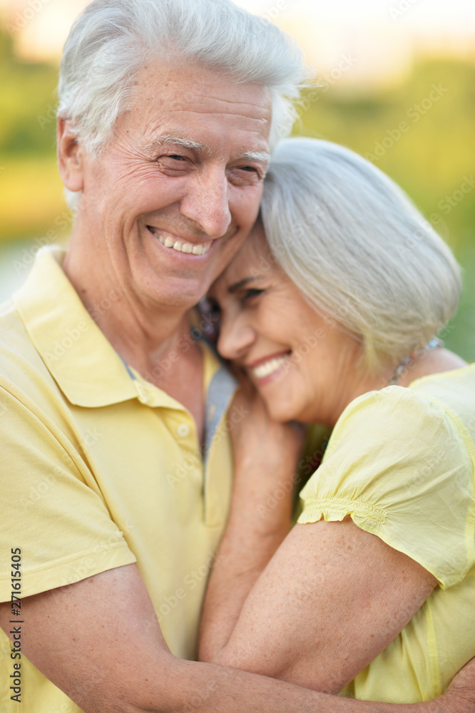 Beautiful senior couple hugging in the park Beautiful senior couple hugging in the park