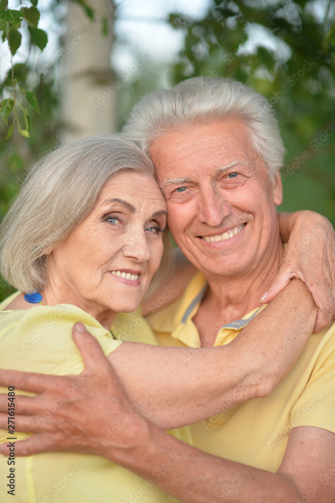 Beautiful senior couple hugging in the park Beautiful senior couple hugging in the park
