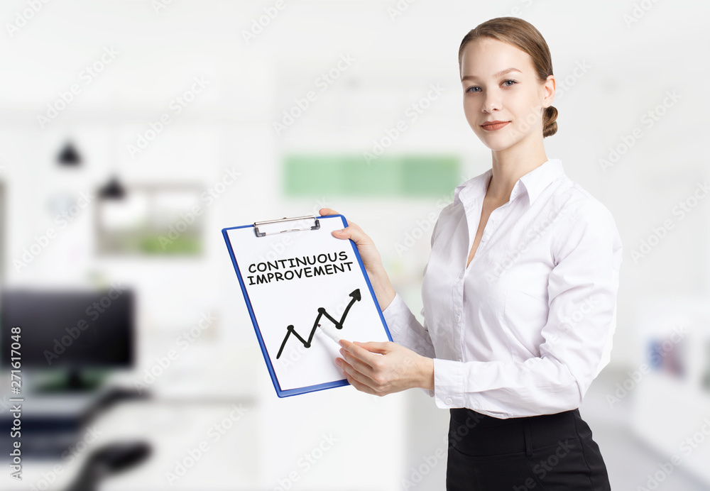 Business, technology, internet and networking concept. Young entrepreneur showing keyword: Continuous improvement Business, technology, internet and networking concept. Young entrepreneur showing keyword: Continuous improvement