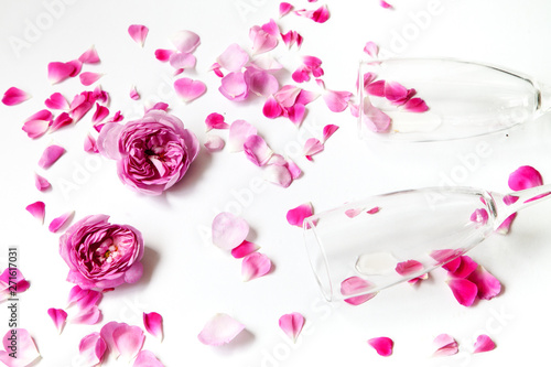 pink roses and glasses on a white background