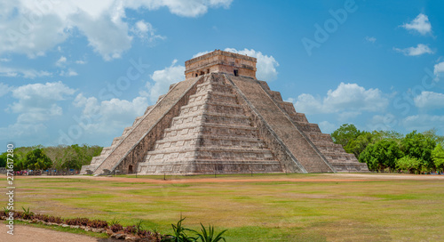 Great Mayan Pyramid of Kukulkan, known as El Castillo, classified as Structure 5B18, taken in the archaeological area of Chichen Itza, between trees and sky, in the Yucatan peninsula