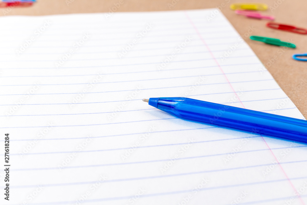 composition with notebook blank page colorful pencil, pen mock-up Back to school concept with stationery office supplies on a brown craft paper background with copy space top view