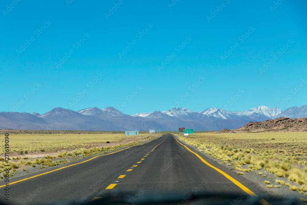 Lonely road in Atacama desert landscape background with copy space for text
