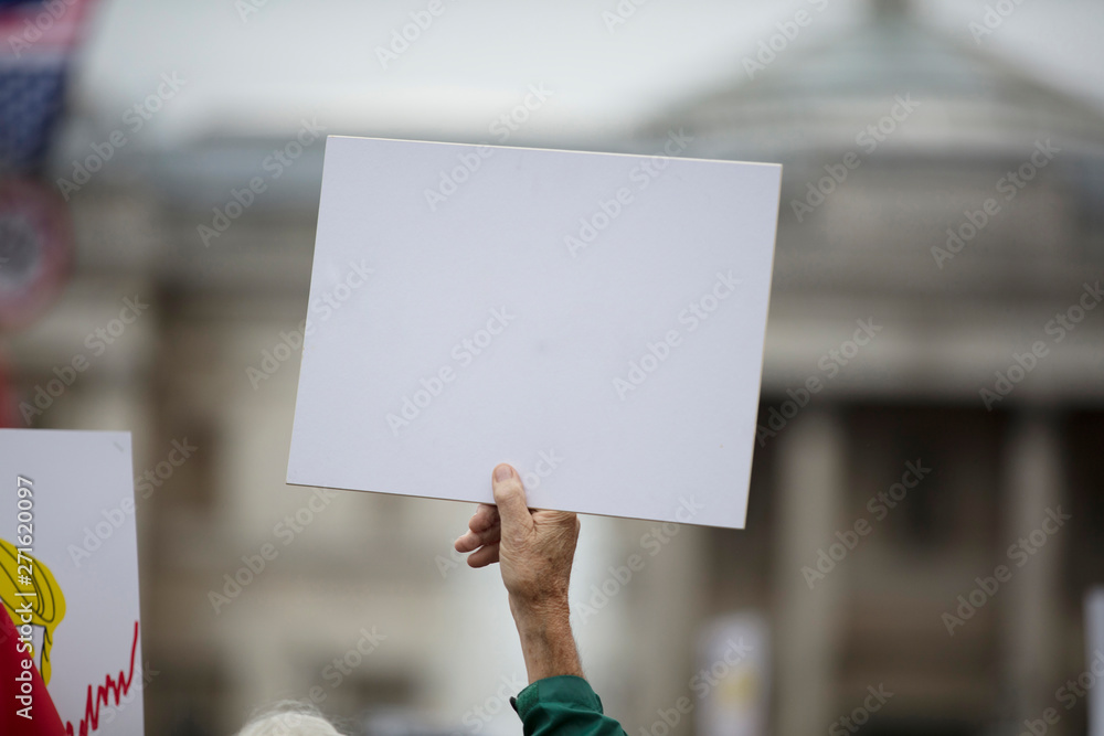 A person holding a blank protest banner at a political rally A person holding a blank protest banner at a political rally
