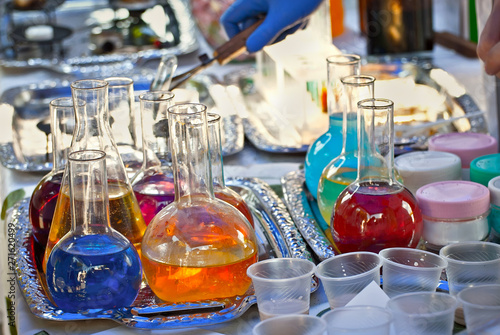 Glass tubes with a multicolored liquid. Demonstration of experiments on chemistry and biology at the school scientific exhibition.