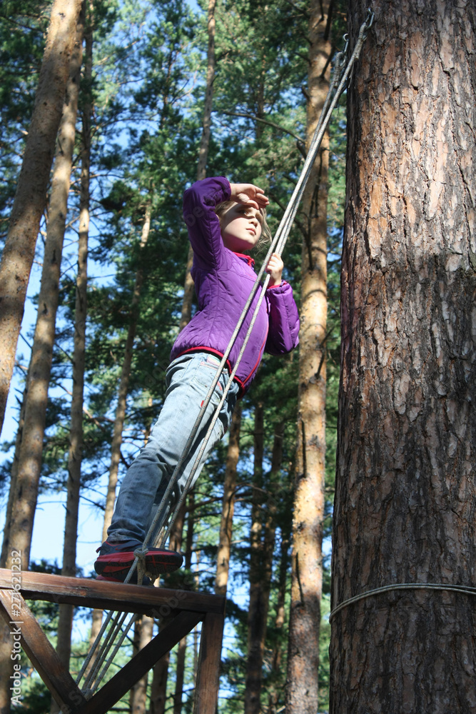 girl stands on a ship in the woods, plays sailor. girl stands on a ship in the woods, plays sailor.