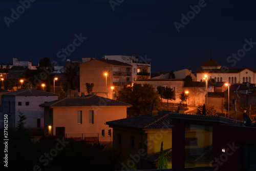 Night city with burning lanterns in the streets.