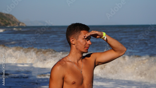 Athletic man in surf waves on the beach