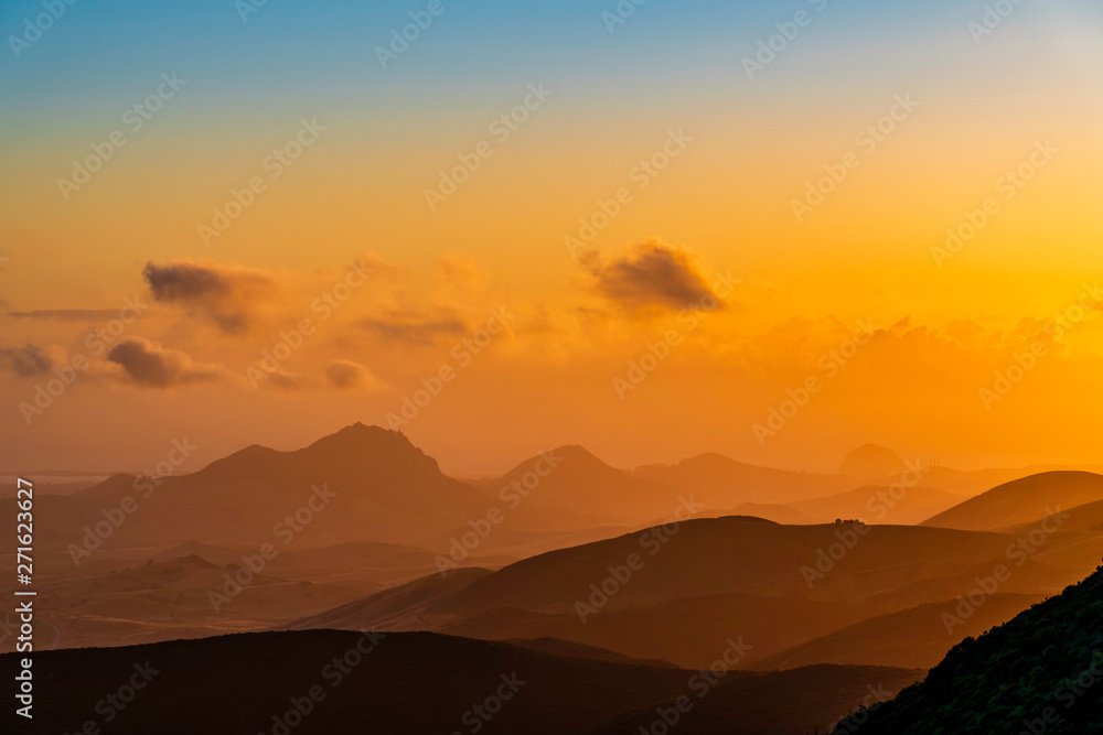 Orange sunset over Silhouetted Mountains