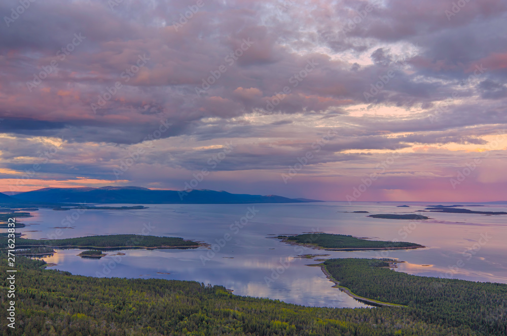 Aerial panorama view of Colorful sunset landscape on the coast of the North Sea. Karelian pine on the rocks on the shore of the White Sea. Coast Murmansk region, Kandalaksha Nature Reserve.