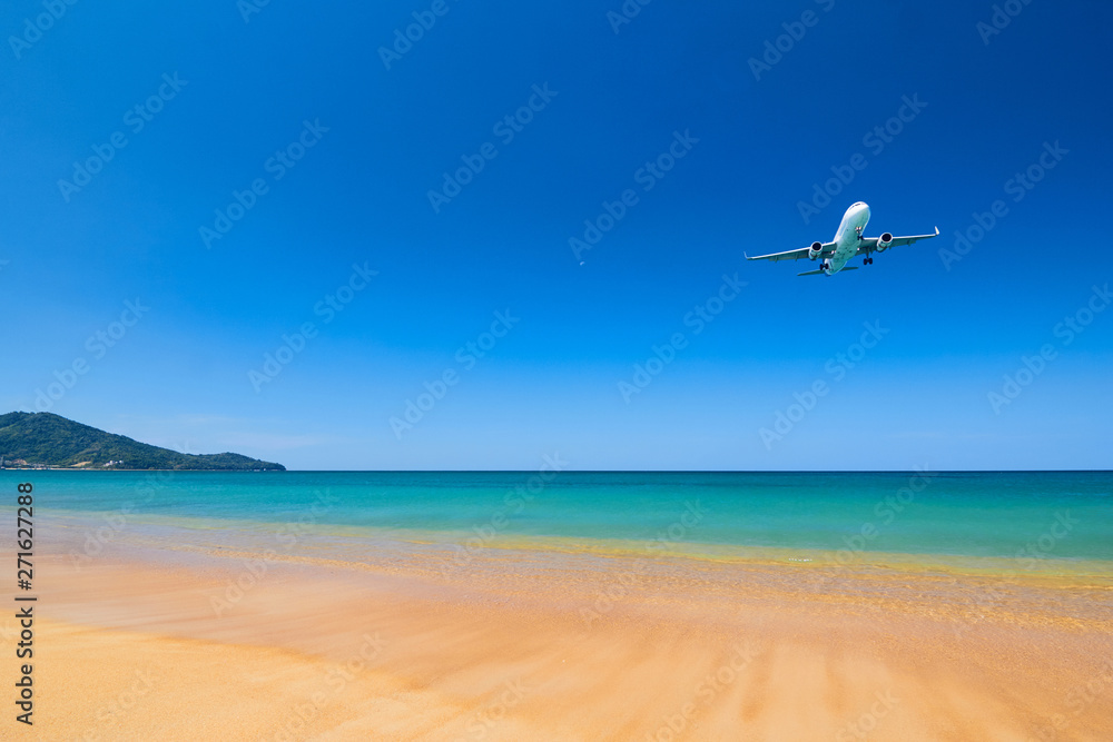 Fototapeta premium Air plane fly over the sand beach and blue sea in Nai Yang beach, Phuket, Thailand