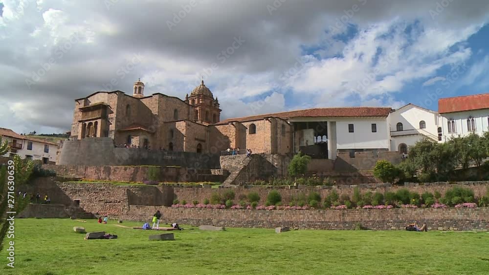 Wide low-angle still shot of Corincancha ruins and Santo Domingo Convent. Thick clouds are hanging on the sky, Cusco, Peru Wide low-angle still shot of Corincancha ruins and Santo Domingo Convent. Thick clouds are hanging on the sky, Cusco, Peru