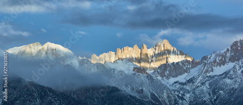 Mount Whitney with sun breaking through clouds to light the peak