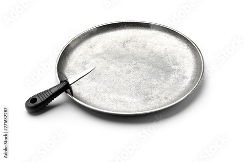 Stainless steel oyster knife with plastic handle on metal tray against white background