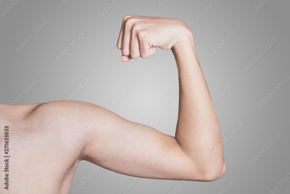 young thin man arm on a grey background. Stock-bilde | Adobe Stock