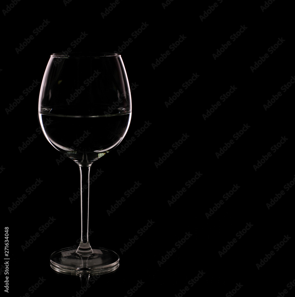 Glass with white wine on a black background Glass with white wine on a black background