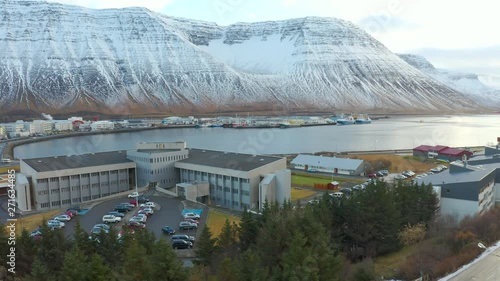 Aerial drone footage of  Isafjordur town in westfjords with impressive mountain ranges surrounding the fjord / inlet of atlantic ocean, Iceland photo