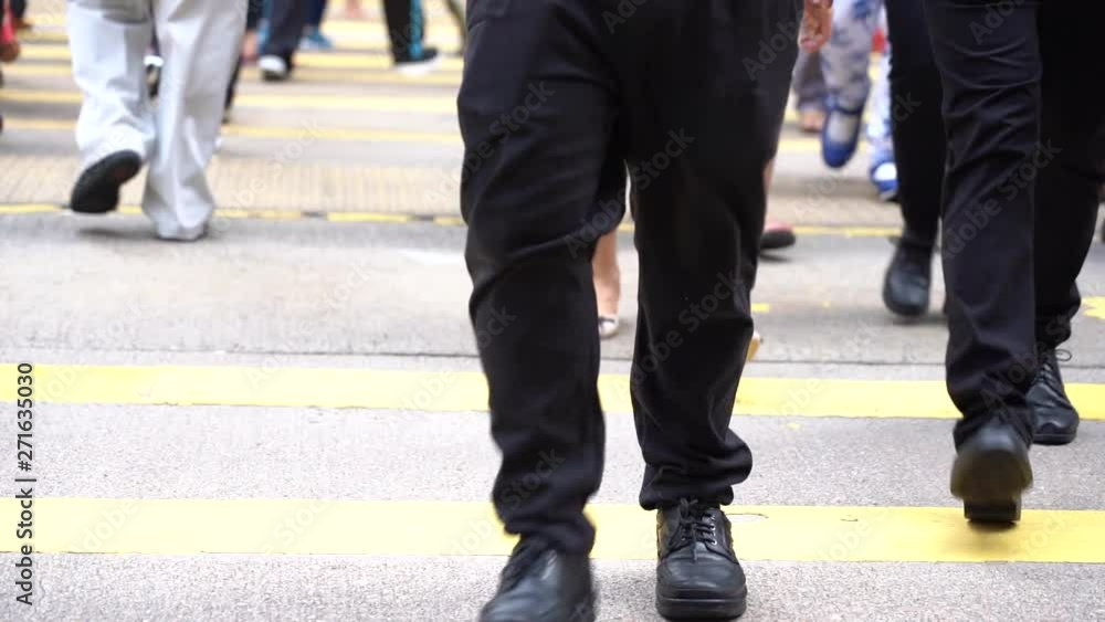 Slow motion of Pedestrians walking over the street in Hong Kong Slow motion of Pedestrians walking over the street in Hong Kong