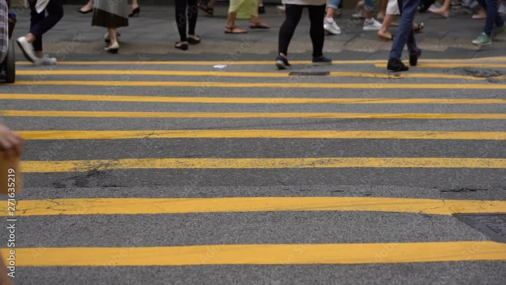 Slow motion of Pedestrians walking over the street in Hong Kong Slow motion of Pedestrians walking over the street in Hong Kong