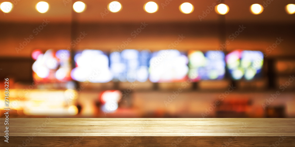 Empty wooden table top with blur coffee shop or restaurant interior background, Panoramic banner.