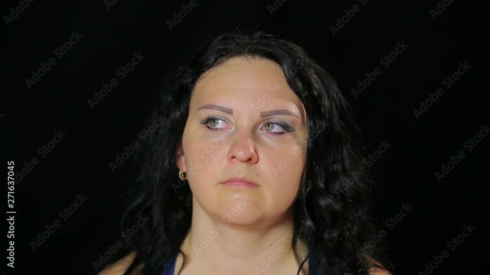 A young woman does exercises with her eyes obliquely. A young woman does exercises with her eyes obliquely.