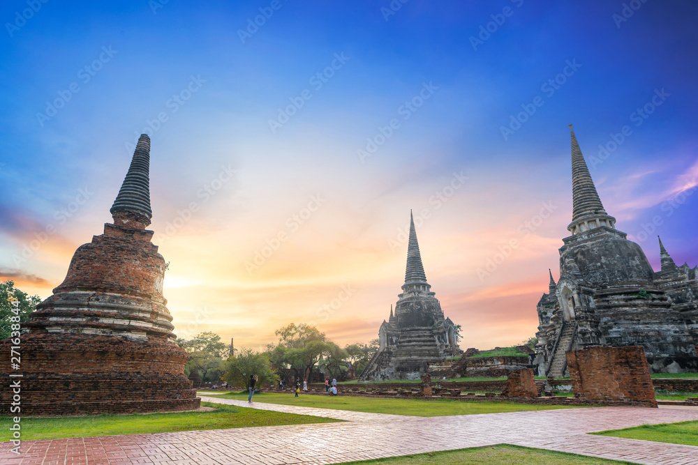 Fototapeta premium Ayutthaya, Thailand- June 2, 2019 : Many people are traveling to visit the beautiful old pagoda and buddha status at Wat Prasrisanpet Temple.