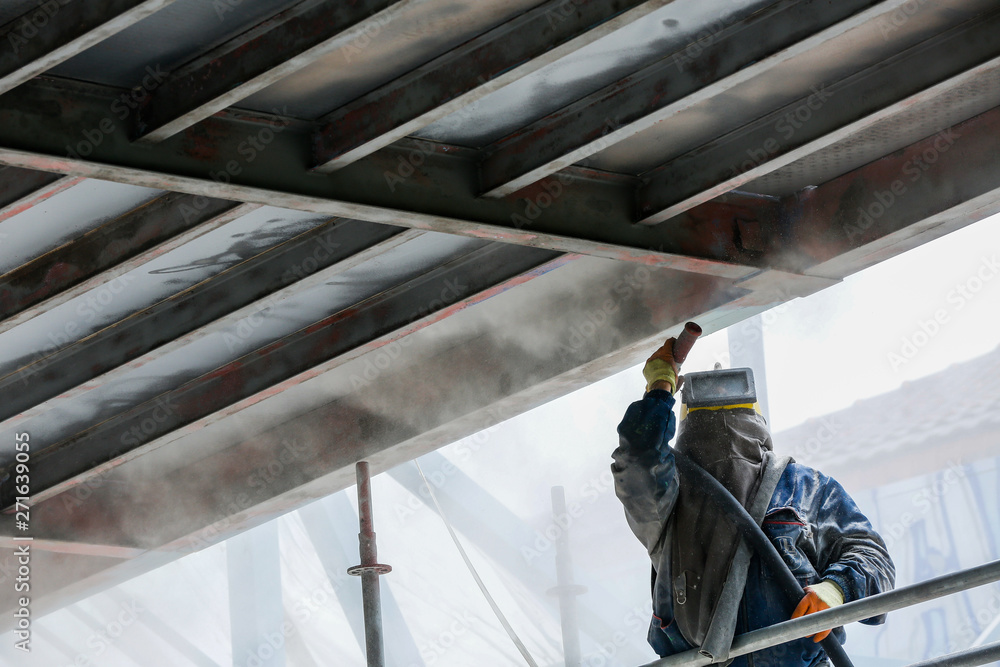Sand blasting process Industial worker using sand blasting process