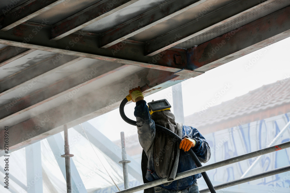 Sand blasting process Industial worker using sand blasting process