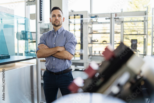 Portrait of confident businessman in a modern factory photo