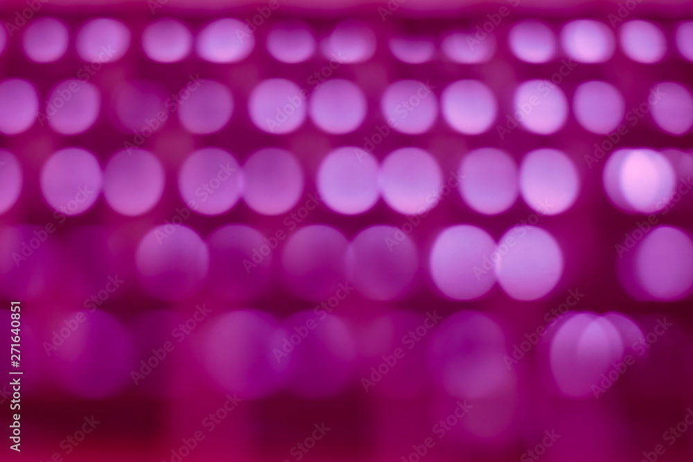 Abstract pink magenta bokeh background with soft focus lights in rows
