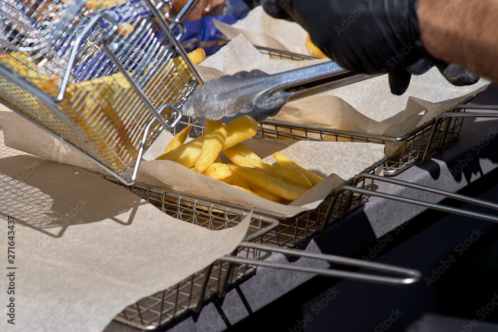 Cooking french fries. Closeup view of making french fries deep frying
