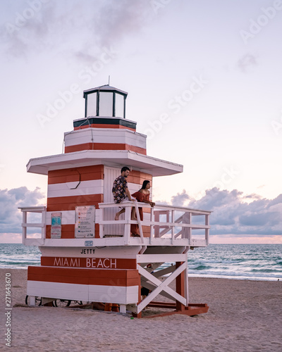 Miami south Beach, youn couple men and woman on the beach during sunrise. Miami beach Floarida © Fokke Baarssen