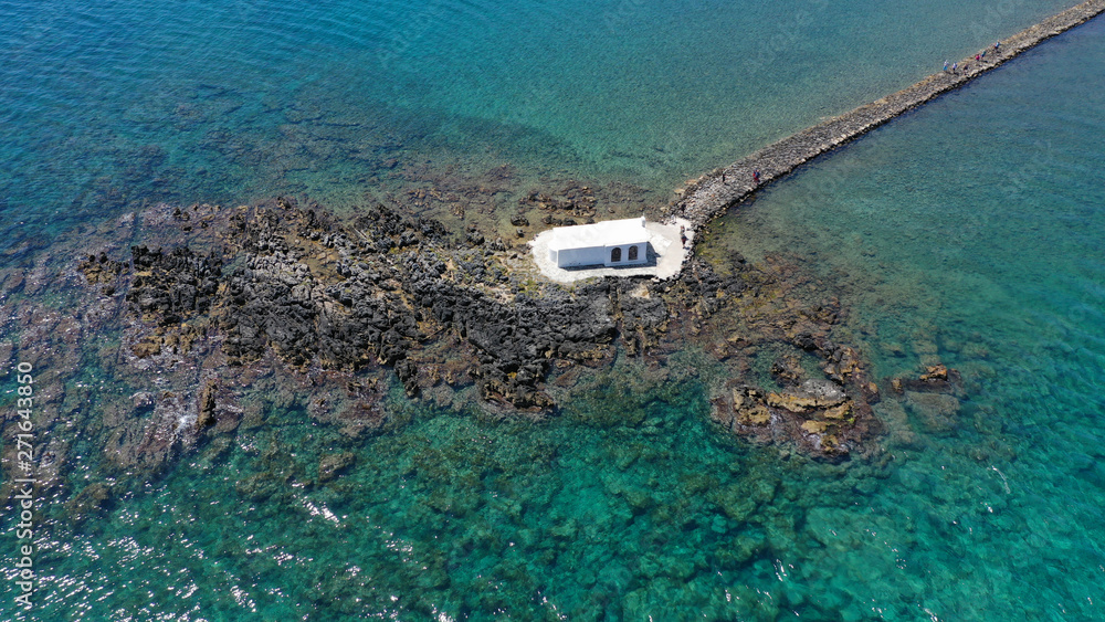 Aerial drone photo of famous for wedding ceremonies chapel of Agios Nikolaos built at sea with a small path connecting to mainland, Georgioupoli, Chania, Crete island, Greece