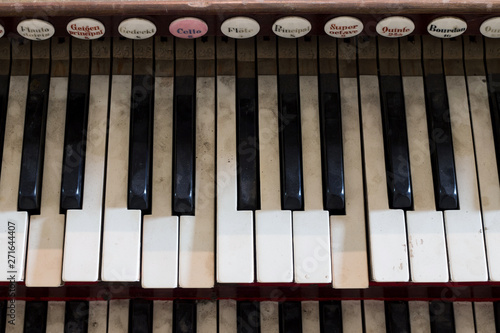 Detail of old, broken and dusty organ keys photo
