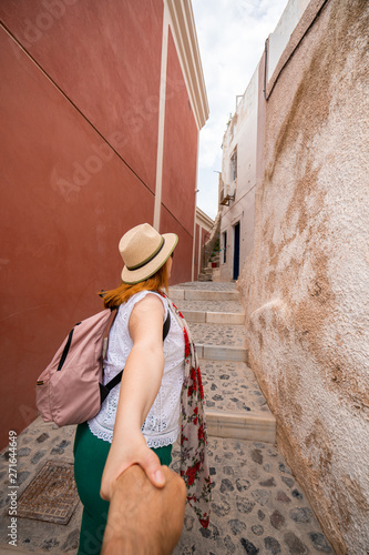 Couple Traveling. Woman holding hand with Man and leading the Way to New Places