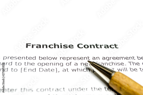 Franchise contract with wooden pen