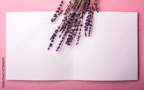 Fototapeta Naklejka Na Ścianę i Meble -  Lavender flowers on a clean notepad. mock up for your design. View from above. Copy space