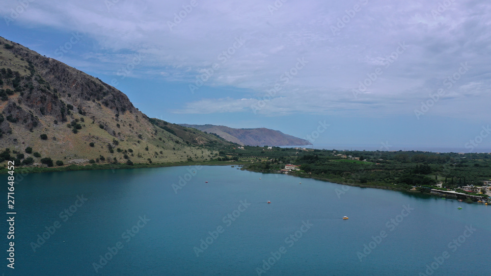 Aerial drone panoramic photo of famous natural lake of Kournas with amazing colours and unique nature surrounded by mountains, Chania prefecture, Crete island, Greece Aerial drone panoramic photo of famous natural lake of Kournas with amazing colours and unique nature surrounded by mountains, Chania prefecture, Crete island, Greece