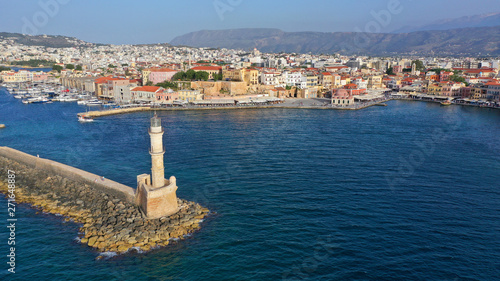 Aerial drone photo of iconic Venetian lighthouse in the entrance of picturesque old port of Chania at sunset with beautiful colours, Crete island, Greece