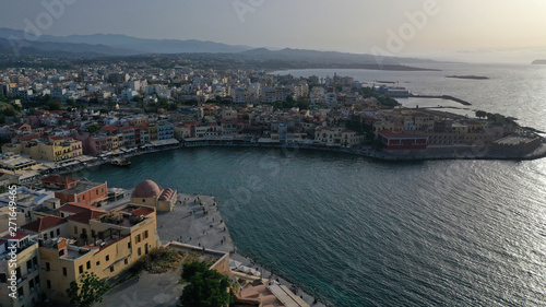 Aerial drone photo of iconic Venetian lighthouse in the entrance of picturesque old port of Chania at sunset with beautiful colours, Crete island, Greece © aerial-drone