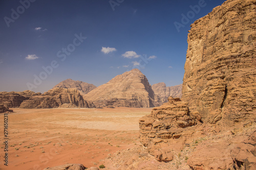 tourism photography of Wadi Rum Jordanian desert scenery landscape with sand valley and different steep and sharp rocky shapes