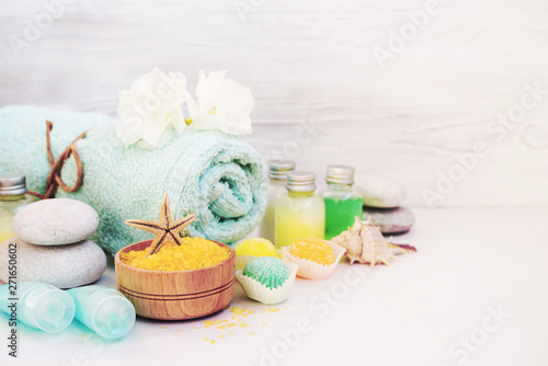 Aromatic salt for Spa therapies, cosmetics for a body and acceptance of bathtubs, towel and a spring flower. Care of a body. Alternative medicine.