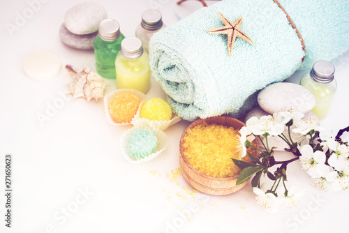 Aromatic salt for Spa therapies, cosmetics for a body and acceptance of bathtubs, towel and a spring flower. Care of a body. Alternative medicine.