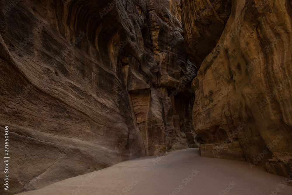 lonely track for tourists inside canyon between steep stone walls 