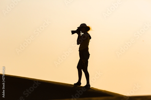 Silhouette of a photographer in the desert
