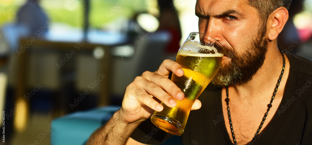 Man holding mug of beer. Sexy bearded man open smile and big mug of beer in his hand. guy at the bar counter.