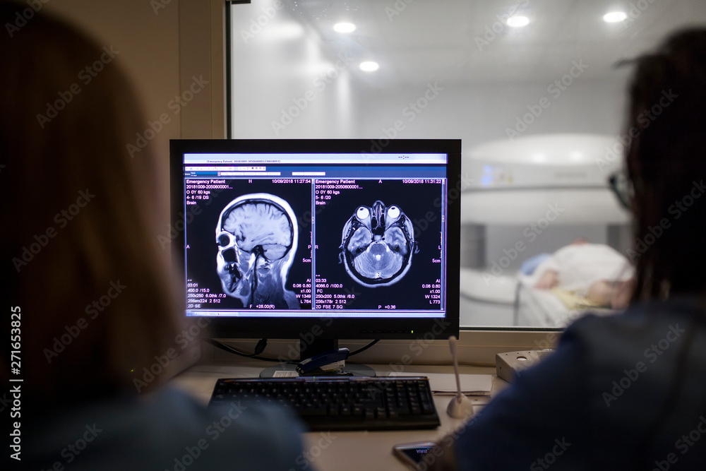 Doctors baling the MRI test in the control room Doctors baling the MRI test in the control room